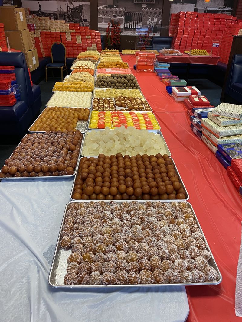 A long table of Indian sweets