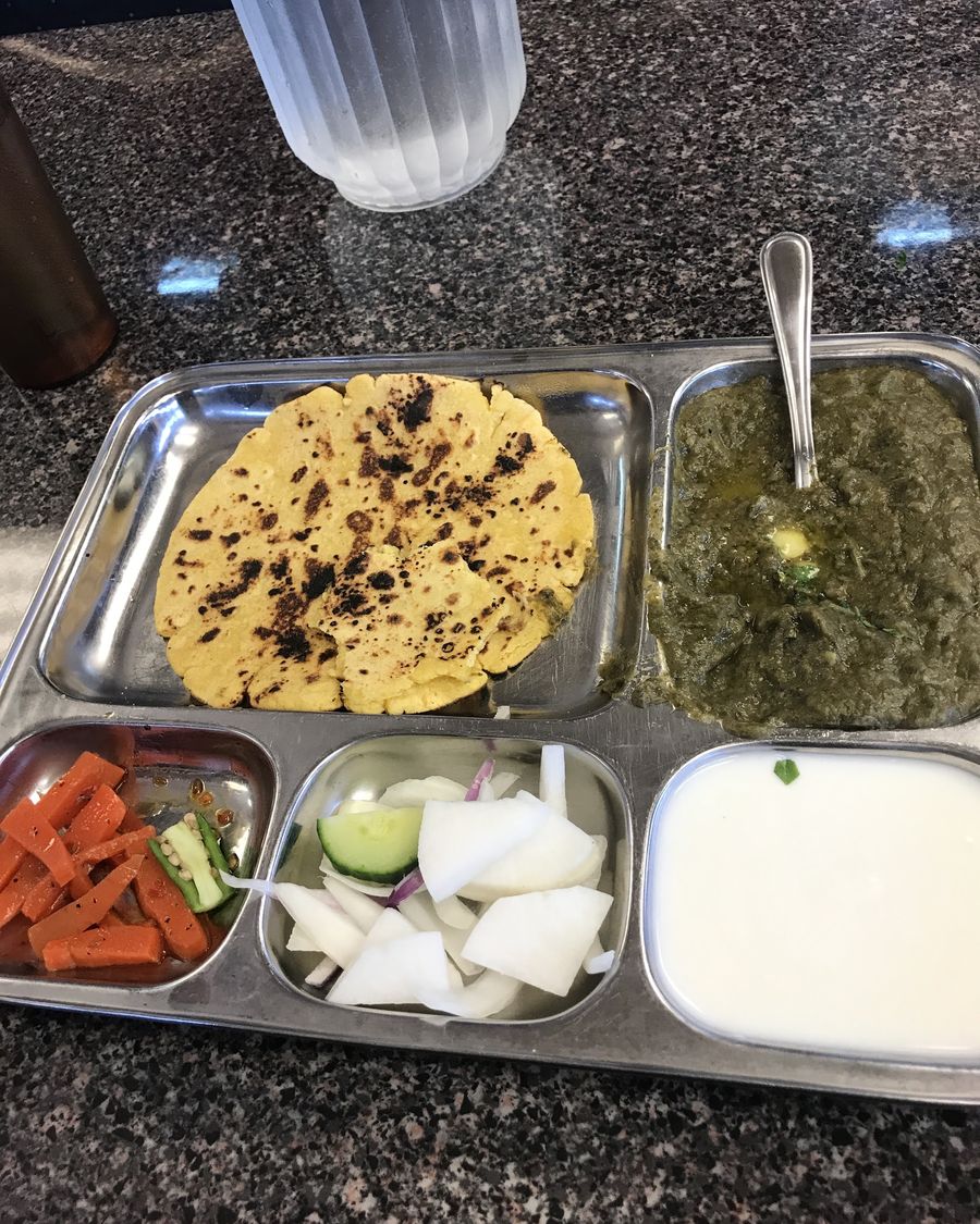 Thali with prantha, curries, raita and salad